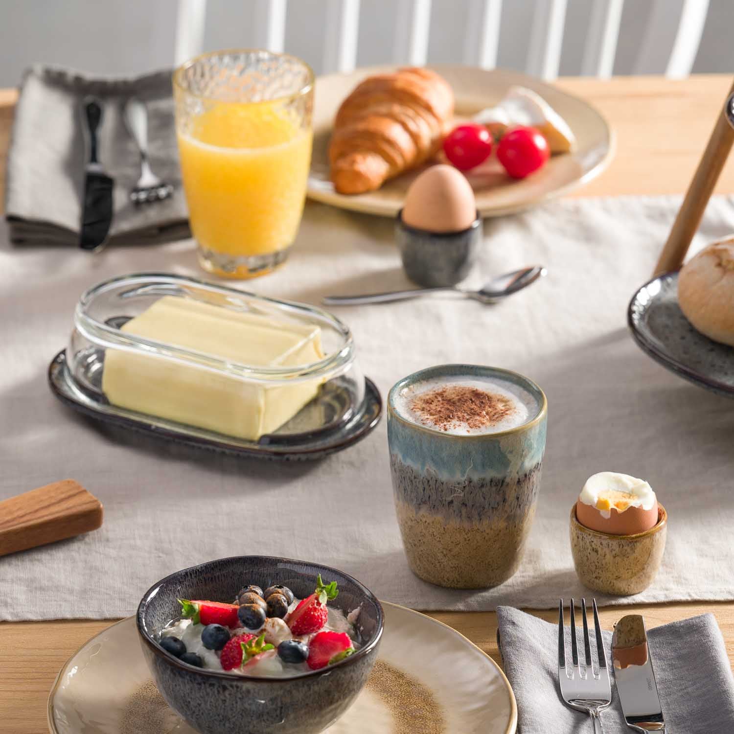Becher MATERA in Keramik auf gedecktem Frühstückstisch mit Croissant, Eiern und Beeren