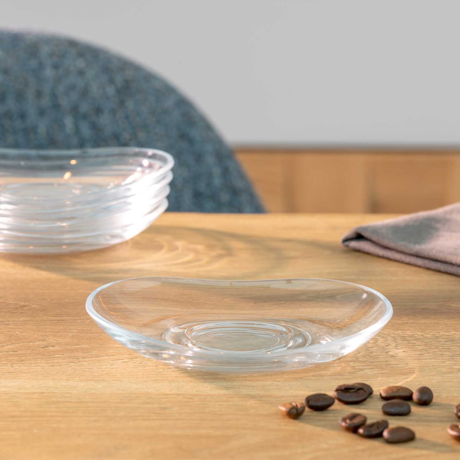 Untertasse NAPOLI auf Holztisch mit Dekoration und Stuhl im Hintergrund