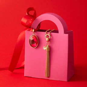 Anhänger PIETRA gold Clip & Mix in rosa Geschenktüte mit roten Bändern