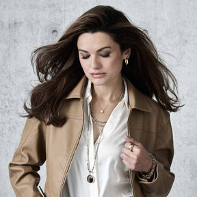 Frau traegt Halskette BERNADETTE 50 cm gold mit weissem Hemd und beigem Jacket