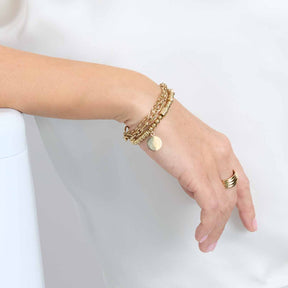 Frau trägt Stretch Armband ELISABETH gold an Handgelenk mit Ring