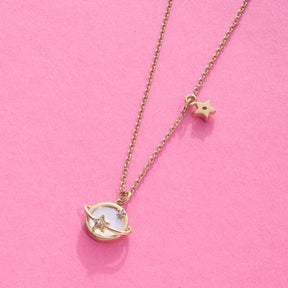 Halskette SATTELITE gold mit Stern-Anhänger auf rosa Hintergrund