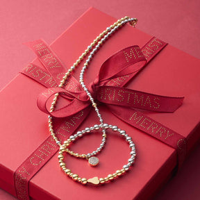 Armband PHILINE gold auf roter Geschenkbox mit Schleife