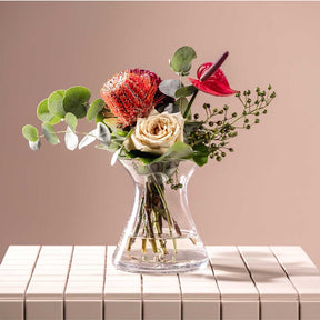 Vase GIA mit Blumenstrauss auf gedecktem Tisch