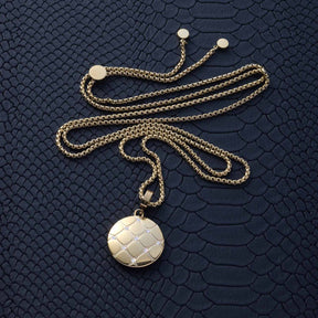Anhänger COCOBELLO Clip & Mix gold mit Kette auf strukturiertem Untergrund