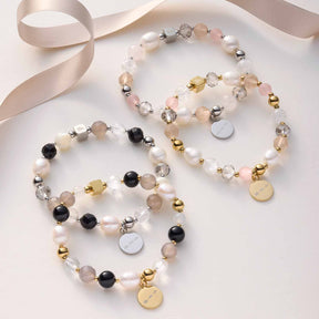 Drei Armbänder HOPE silber/rose auf weißem Untergrund mit Schleife