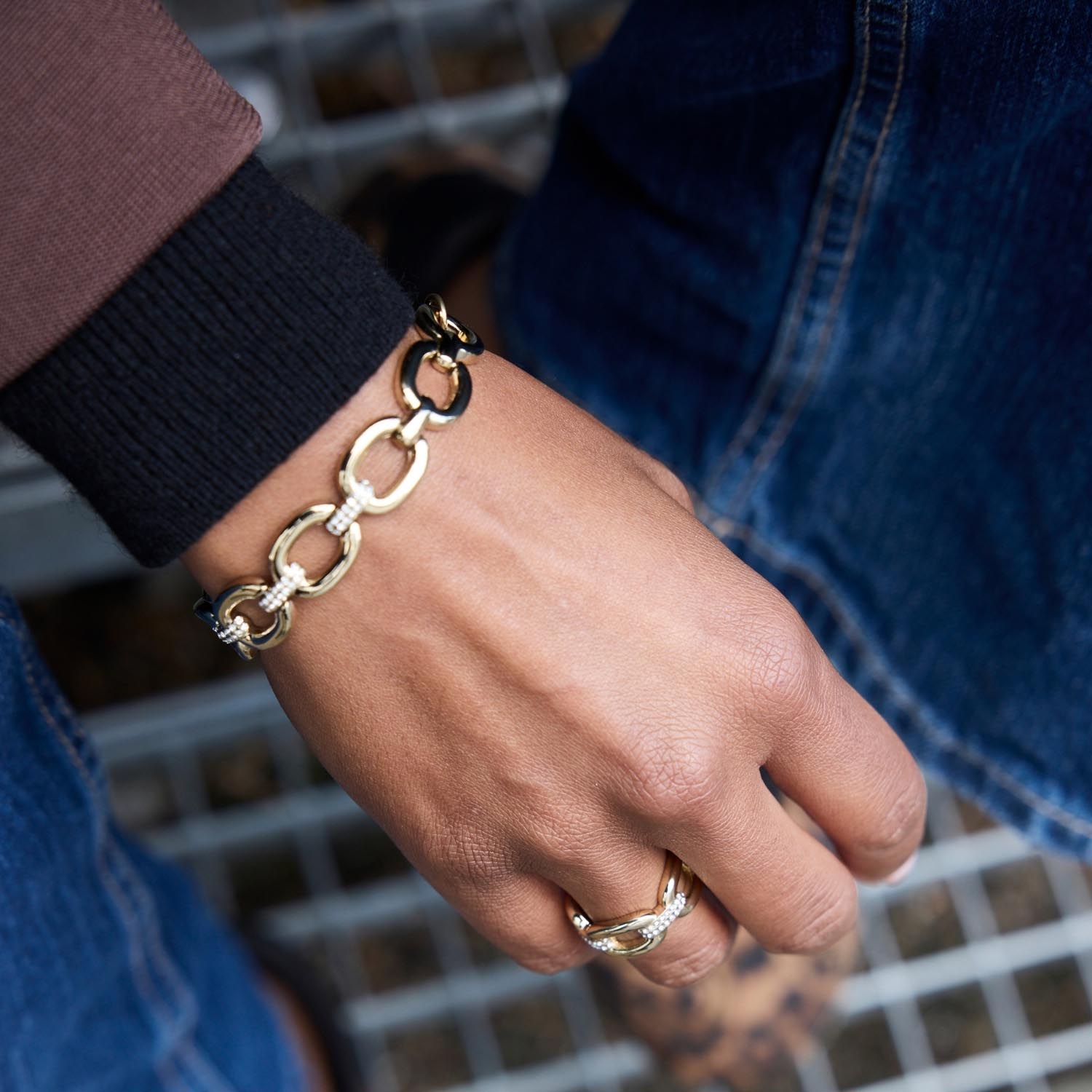 Armband BELLE gold an Hand einer Person mit Ring, Nahaufnahme