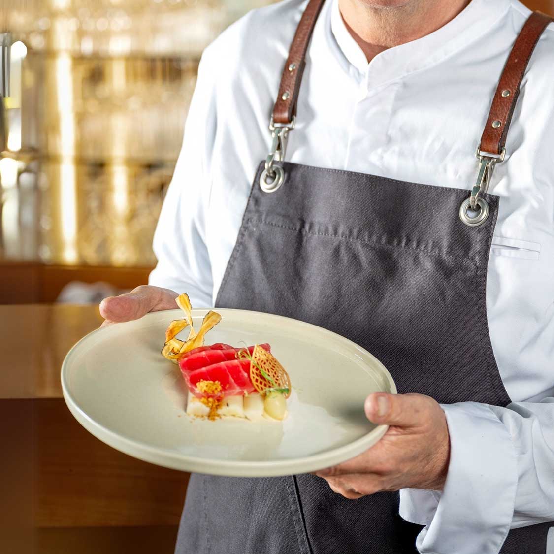Chef präsentiert Keramikteller ROMA mit angerichtetem Gericht