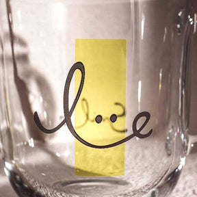 Glastasse EMOZIONE 400 ml mit lächelndem Gesicht und gelber Gravur