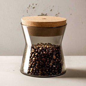 Dose FORMA X mit Korkdeckel gefüllt mit Kaffeebohnen auf weißer Oberfläche