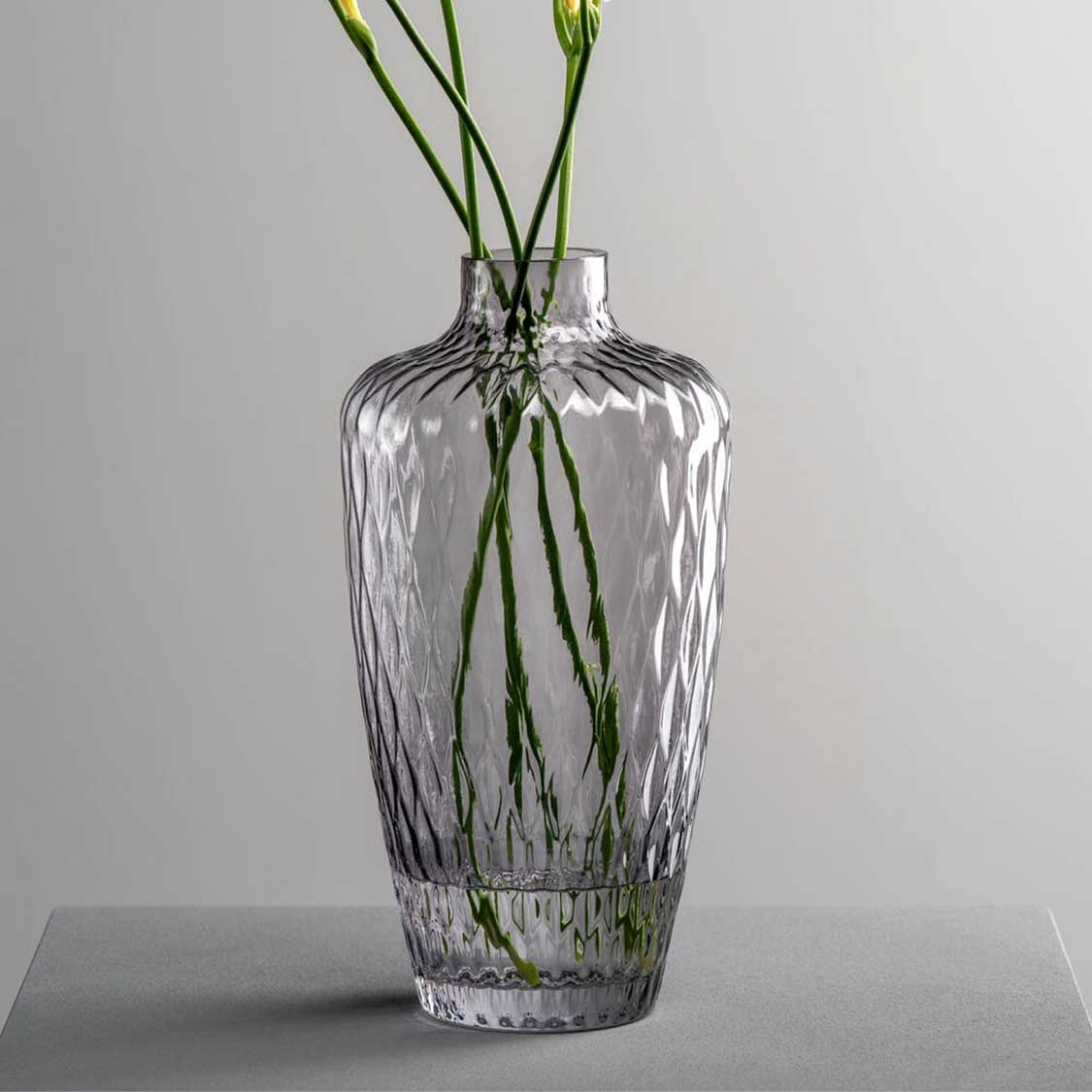 Vase GIULIA 28 cm grau mit grünen Blütenstängeln auf grauem Untergrund