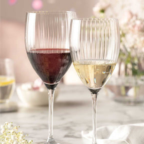 Zwei Weißweingläser POESIA mit Rotwein und Weißwein auf gedecktem Tisch