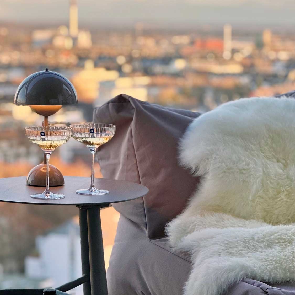 Champagnerschale POESIA auf Balkontisch mit Stadtblick