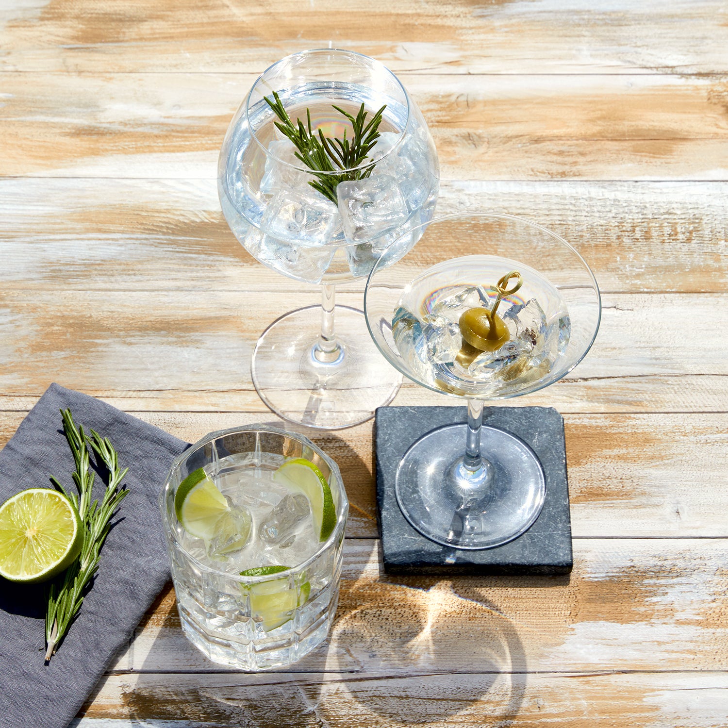 Gingläser GIN 630 ml 2er-Set mit Eis, Zitrone und Rosmarinzweigen auf Holztisch