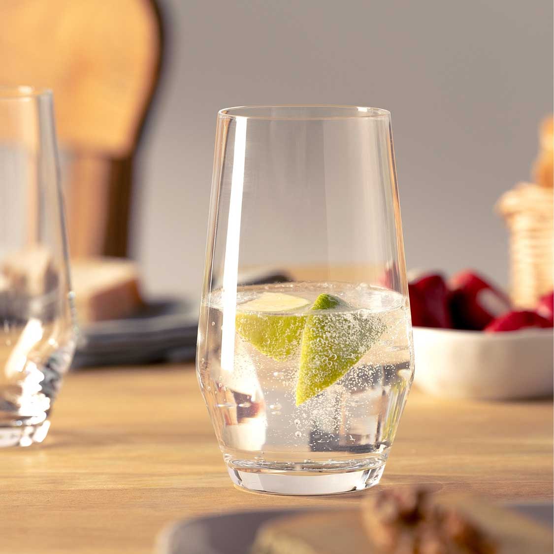 Trinkglas PUCCINI mit Limette und Eiswürfeln auf gedecktem Tisch