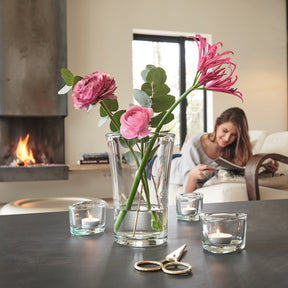 Glasvase BLOOM mit rosa Blüten in modernem Wohnzimmer mit Kamin