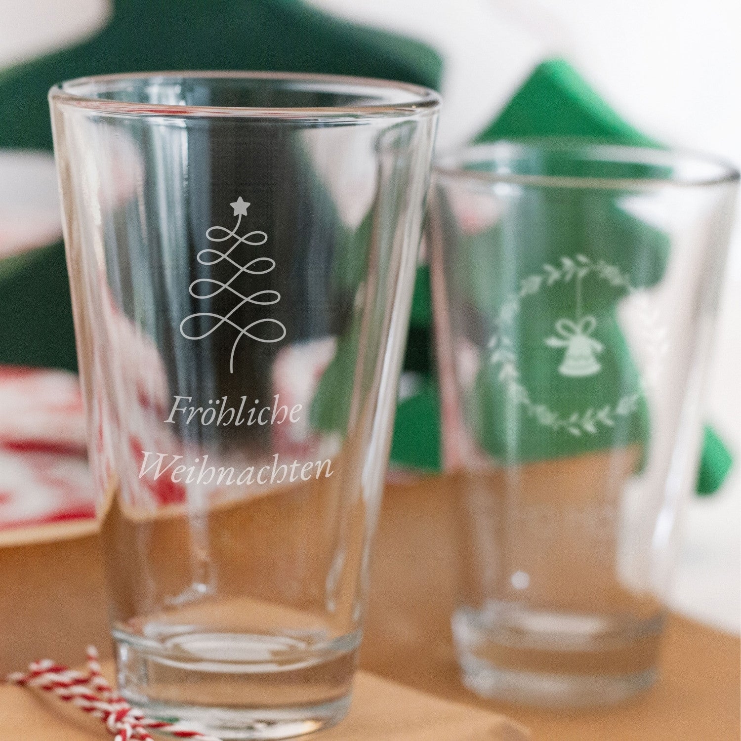 Trinkglas CIAO mit Weihnachtsgravur auf festlich dekoriertem Tisch
